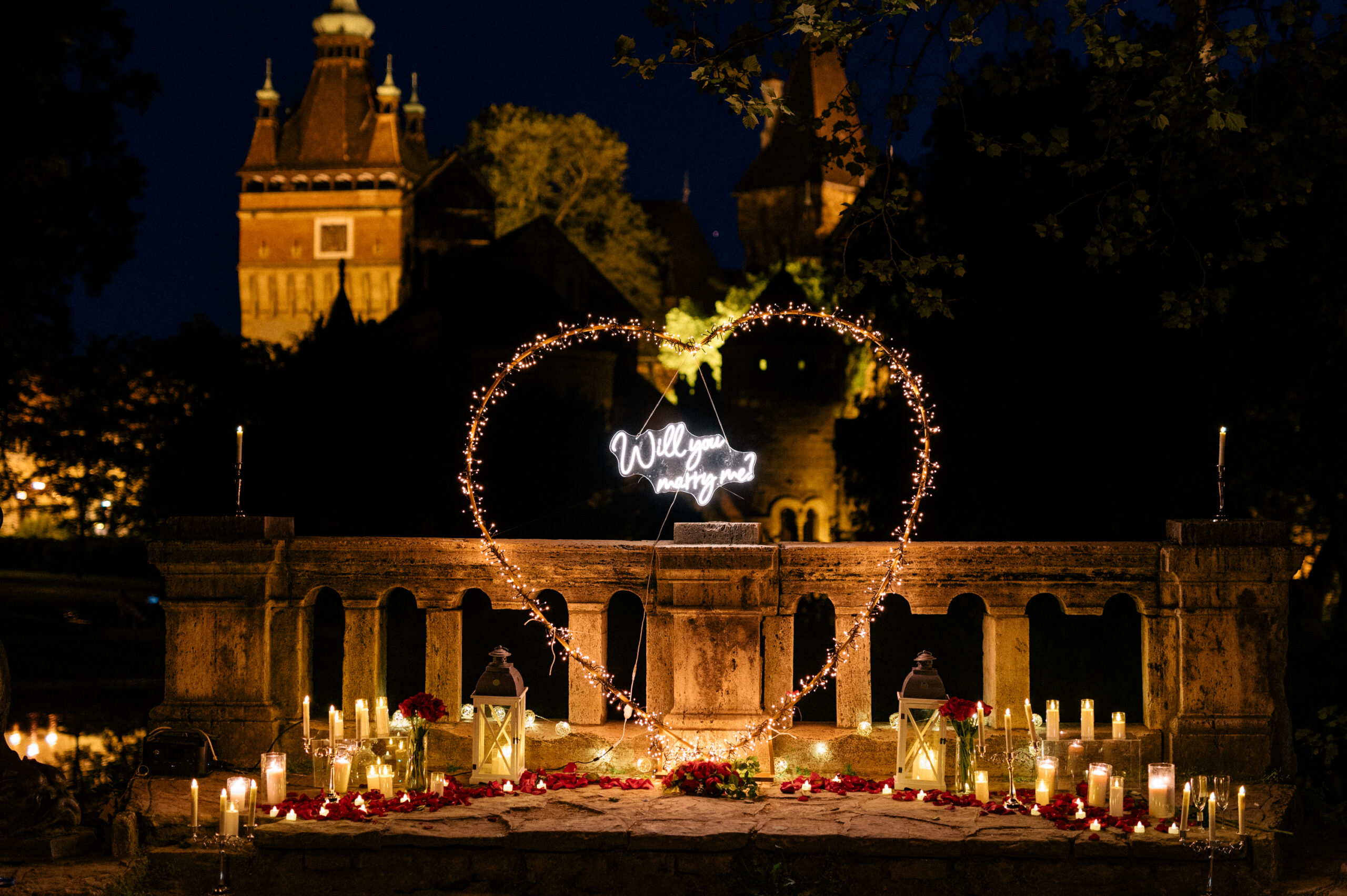Candlelit marriage proposal near Bran Castle at night, Romania